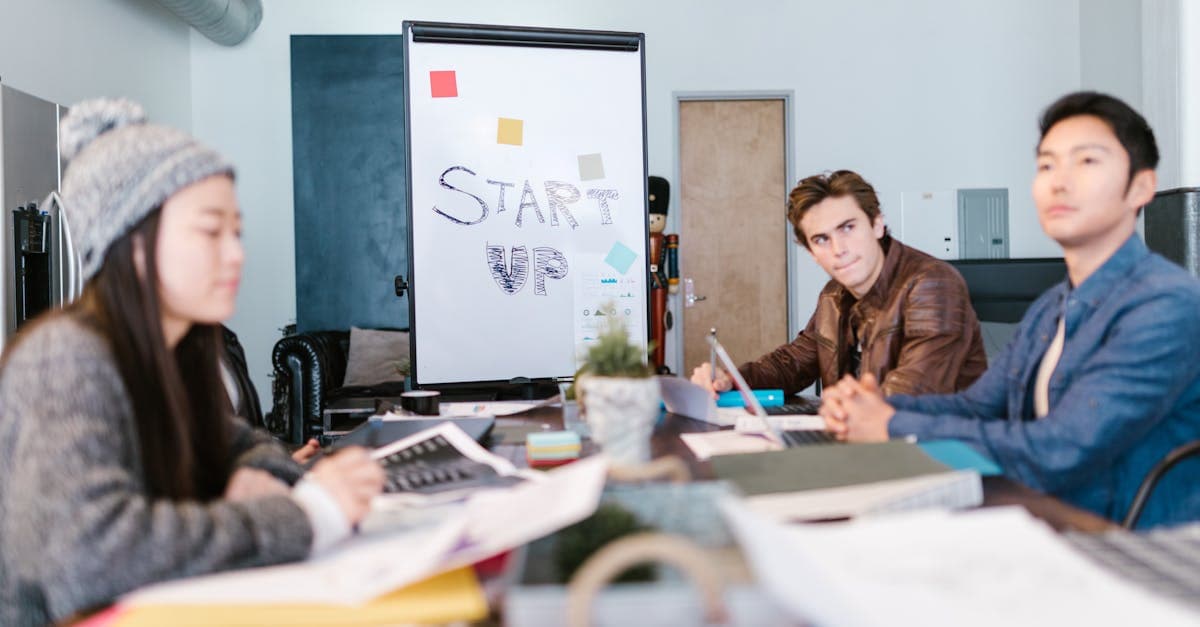 Business registration documents on a desk with a laptop